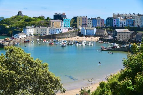 a view of a beach with boats in the water at Tenby House in Tenby