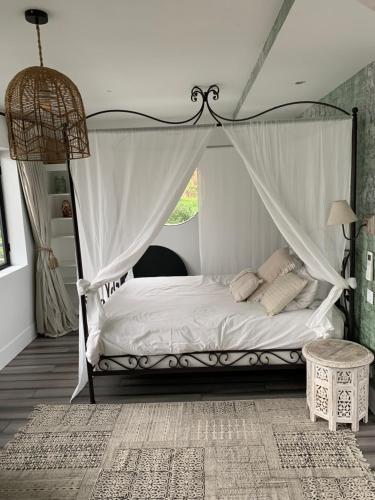 a bedroom with a bed with a canopy at Loft sur l'eau avec parking in Paris