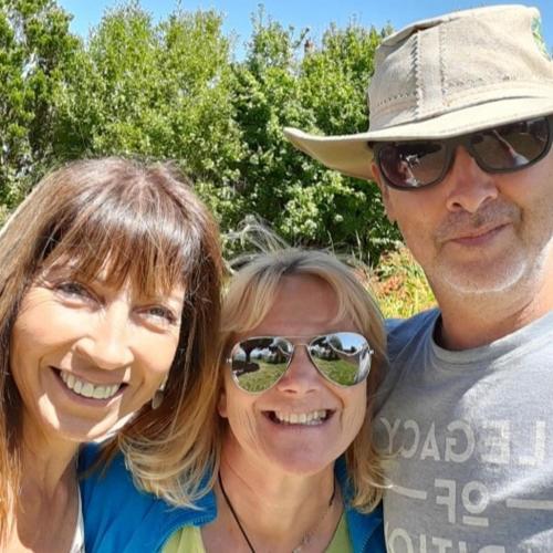 a man and two women posing for a picture at Hostal y Cabañas Mozart in Puerto Montt