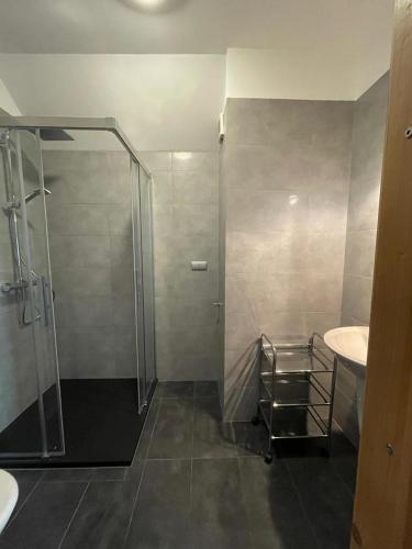 a bathroom with a shower and a sink at Apartamenty Mitori in Dywity