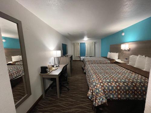 A bed or beds in a room at Baymont by Wyndham Bellevue - Omaha