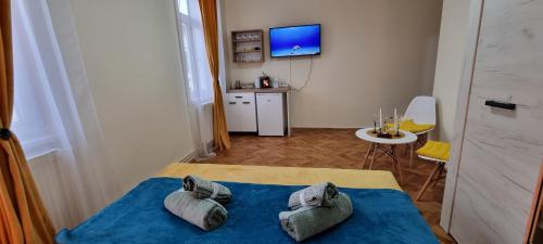 a bedroom with a bed with two pillows on it at Happy Mood Apartments in Braşov