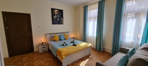 un dormitorio con una cama y un sofá en Happy Mood Apartments, en Brasov