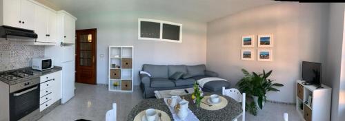 a living room with a couch and a table at Apartamento Chamela in O Pindo
