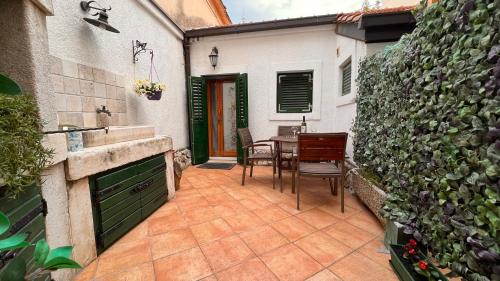 a patio with a sink and a table with a fence at Guesthouse F in Split