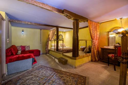 a bedroom with a bed and a couch in a room at Fatma Hanoum boutique hotel in Rhodes Town