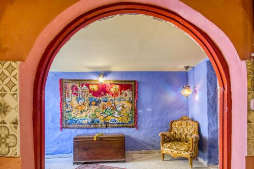 an archway with a chair and a painting on a wall at Fatma Hanoum boutique hotel in Rhodes Town