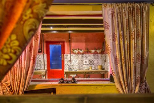 a view of a kitchen with a red door at Fatma Hanoum boutique hotel in Rhodes Town