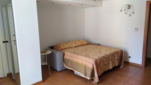 a small bedroom with a bed and a table at I love Rapallo La casa AlMar in Rapallo
