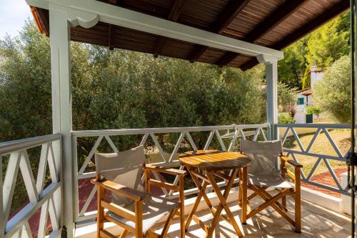 a porch with a table and chairs on a deck at Casa Villa, Xenia Paliouri in Paliouri