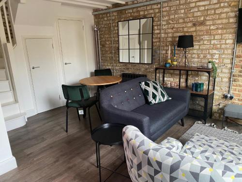 a living room with a couch and a table at The Old Gin Distillery est 1850 in London