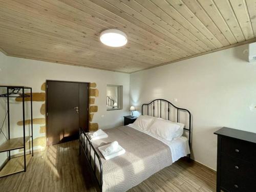 a bedroom with a bed with a wooden ceiling at Villa Eftychia Serene Getaway with Hot Tub in a Quiet Location in Kissamos