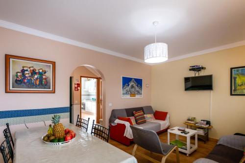 a living room with a table and a couch at My Second House in Manta Rota