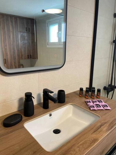 a bathroom with a sink and a mirror at Villa Eftychia Serene Getaway with Hot Tub in a Quiet Location in Kissamos