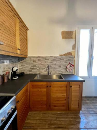 a kitchen with a sink and a stove at Villa Eftychia Serene Getaway with Hot Tub in a Quiet Location in Kissamos