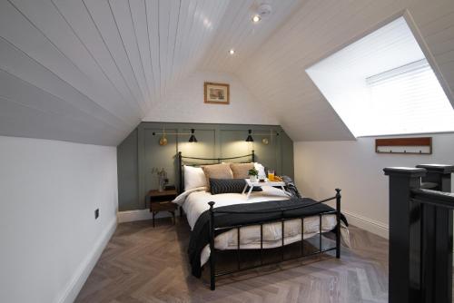 a attic bedroom with a bed and a skylight at Modern finish to a historic brewers house, Derby in Derby