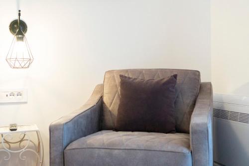 a chair with a pillow in a living room at Herceg Vila in Trebinje