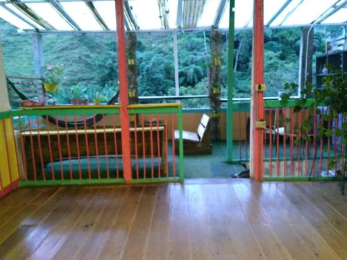 a room with a wooden floor and a large window at HOSTAL CASA VICTORIA PIJAO in Pijao
