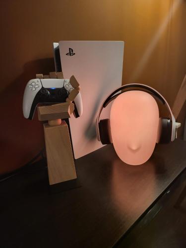 a table with a video game controller and a lamp at SPAre-Time - Exclusive and Unique Apartment! 18+ in Oradea