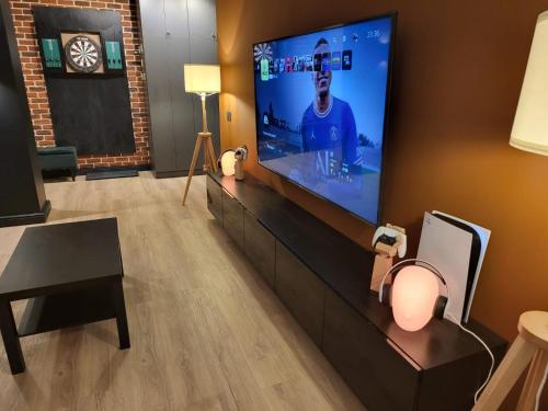 a living room with a flat screen tv on a wall at SPAre-Time - Exclusive and Unique Apartment! 18+ in Oradea