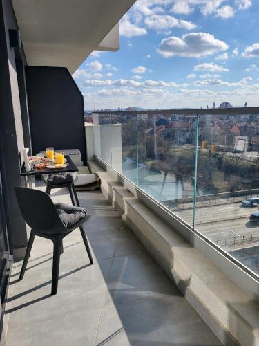 a balcony with a table and a view of a river at SPAre-Time - Exclusive and Unique Apartment! 18+ in Oradea