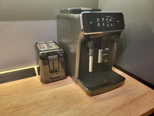 a coffee maker and a toaster sitting on a table at SPAre-Time - Exclusive and Unique Apartment! 18+ in Oradea