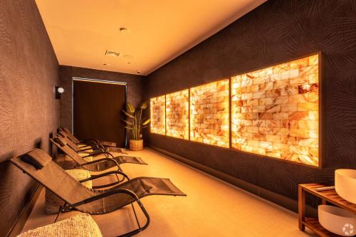 a waiting room with chairs and a stone wall at Luxury Apartments by Hyatus at Pierpont in New Haven