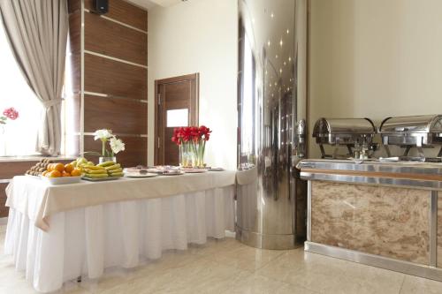 a buffet line with fruits and vegetables on a table at Gran Hotel Corona Sol in Salamanca