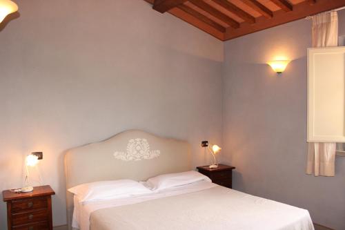 Ein Bett oder Betten in einem Zimmer der Unterkunft Relais I Piastroni