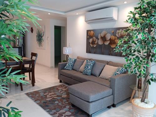 a living room with a couch and a table at Marina del Sol Resort Condo directly on the Ocean 102 in Mazatlán