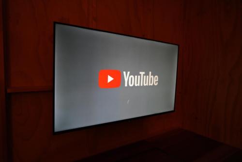 a monitor with a youtube sign on a wall at JR Mobile Inn Sapporo kotoni in Sapporo