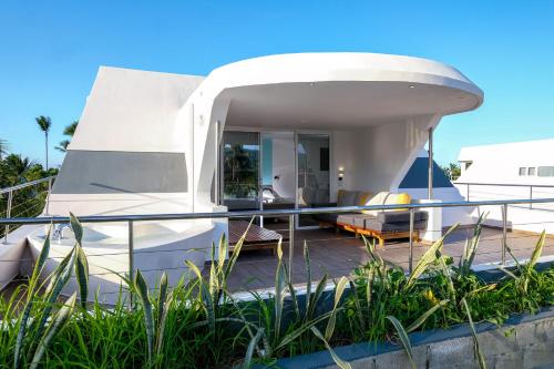 a house on a boat with a balcony at Puerto Plaza Las Terrenas in Las Terrenas