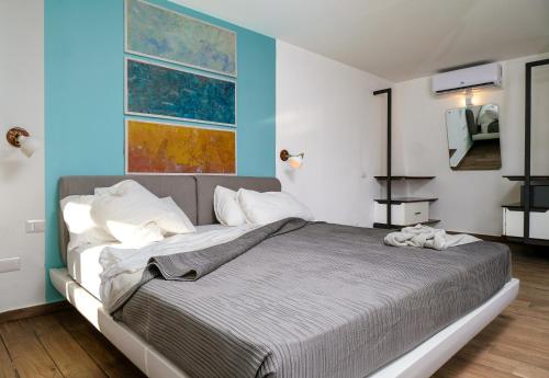 a bedroom with a large bed with blue walls at Puerto Plaza Las Terrenas in Las Terrenas