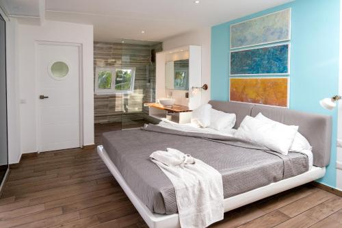 a bedroom with a large bed and a bathroom at Puerto Plaza Las Terrenas in Las Terrenas