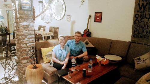 a man and a woman sitting on a couch at RANGBAARI STAYS & CAFE in Jodhpur