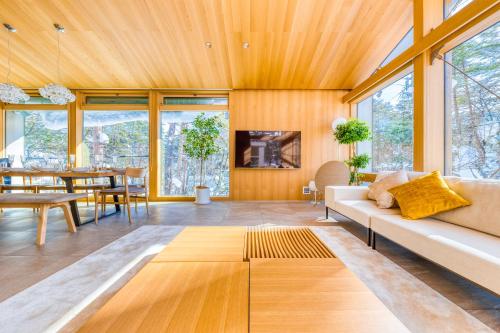 a living room with a couch and a table at Hakuba Amber Resort by Jade Group in Hakuba