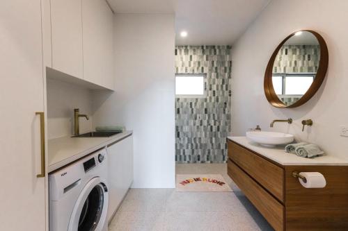 a bathroom with a sink and a washing machine at Central Hideaway-close to everything in Warrnambool