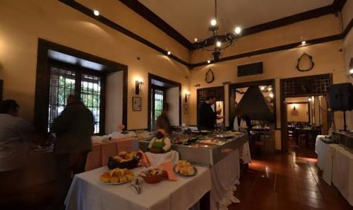 a restaurant with white tables and people in a room at Howard Johnson Hotel Rinconada de Los Andes in Los Andes