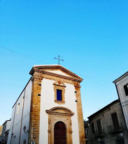 a tall building with a cross on top of it at Alessi Suites & Studio in Mazzarino