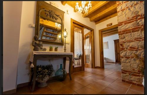 a living room with a fireplace and a mirror at Hotel Rural en Las Cascadas de Tobera in Tobera