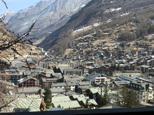 a town in the mountains with houses and buildings at Triftbach - View over Zermatt in Zermatt