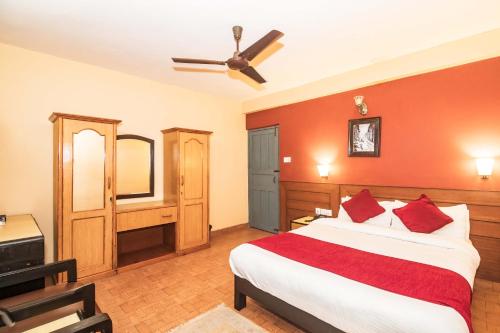 a bedroom with a bed and a ceiling fan at Hotel Silver Oaks Inn in Pokhara
