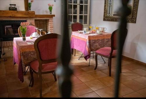 a dining room with a table and chairs and a fireplace at Hotel Rural en Las Cascadas de Tobera in Tobera
