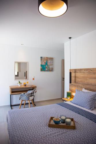 a bedroom with a bed with a table and a desk at Adrianna Villa 4ppl in Bali