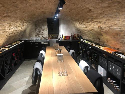 a dining room with a wooden table and wine racks at Padise Manor in Padise