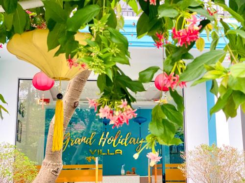 a flower shop front with a sign that reads happy holidays villa at Grand Holiday Hoian Villa in Hoi An