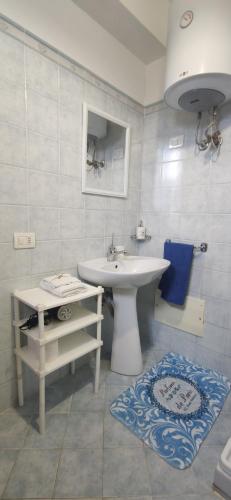 a white bathroom with a sink and a toilet at Vigna al Parco in Alvito