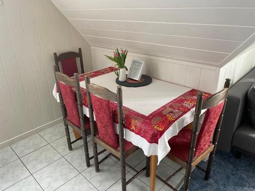 a dining room table with a red and white table cloth at Niebieska Tawerna in Węgorzewo