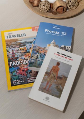 three magazines sitting on top of a table at Il Riccio Apartment 28 in Procida