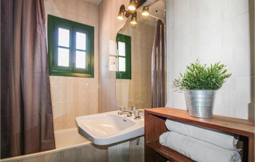 a bathroom with a sink and a mirror and a tub at Beautiful Home In Frigiliana With Wifi, Private Swimming Pool And Swimming Pool in Frigiliana